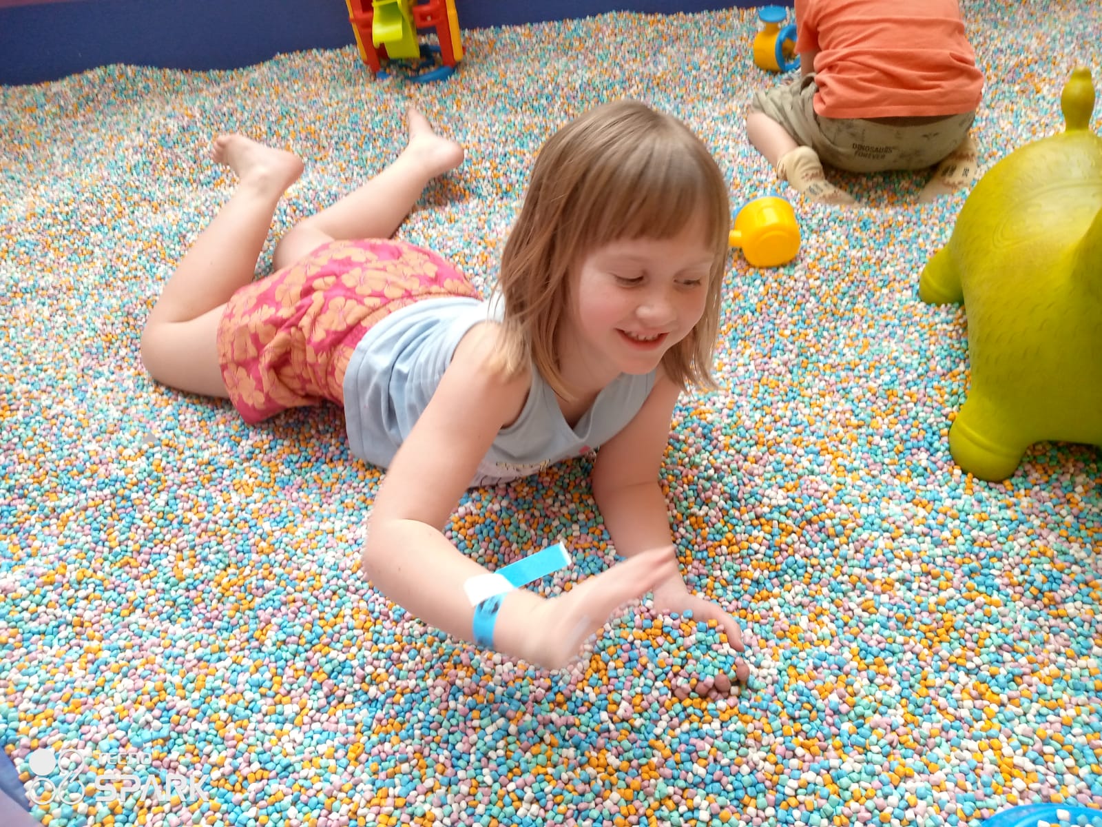 Child playing with yellow construction toys
